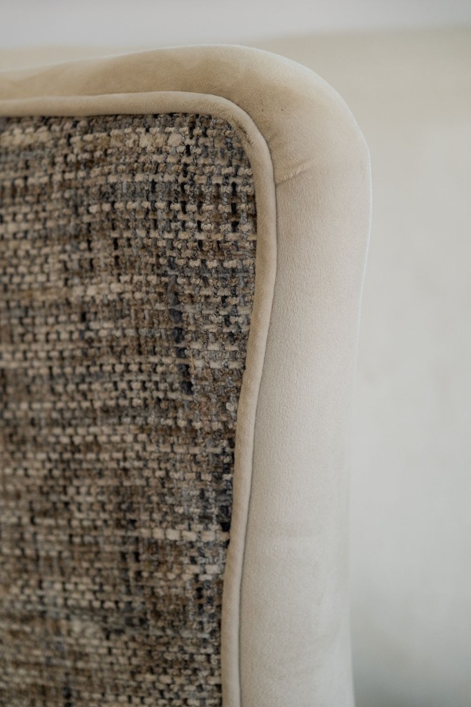 Close-up of woven and velvet upholstery detailing on living room seating